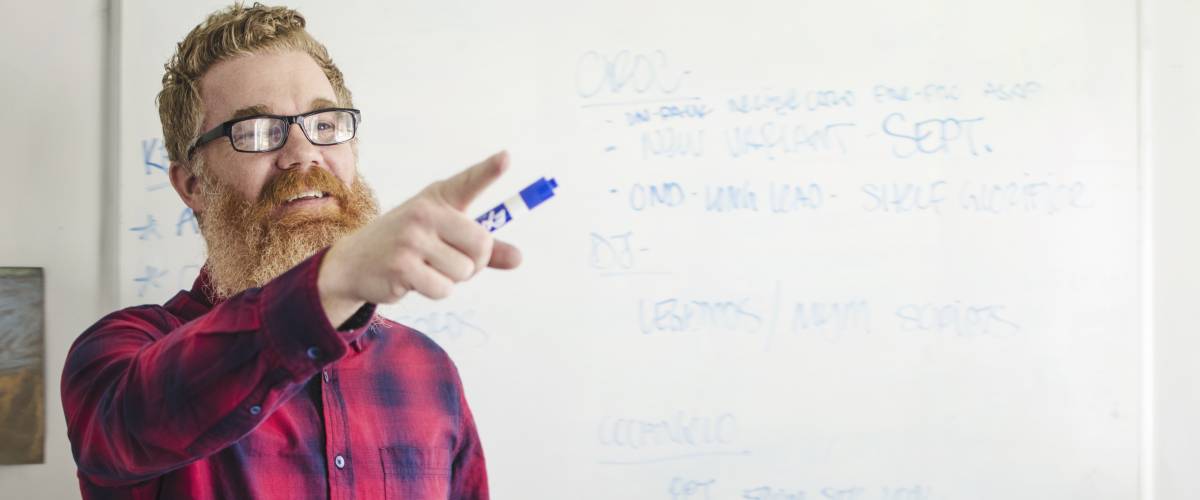 Man teaching class at whiteboard