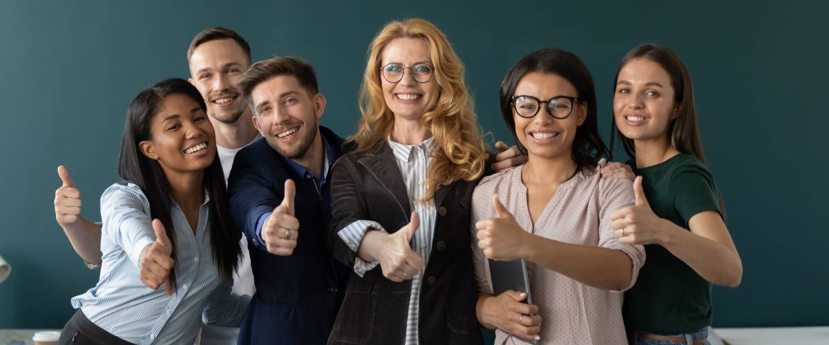 Overjoyed multicultural colleagues show thumbs up