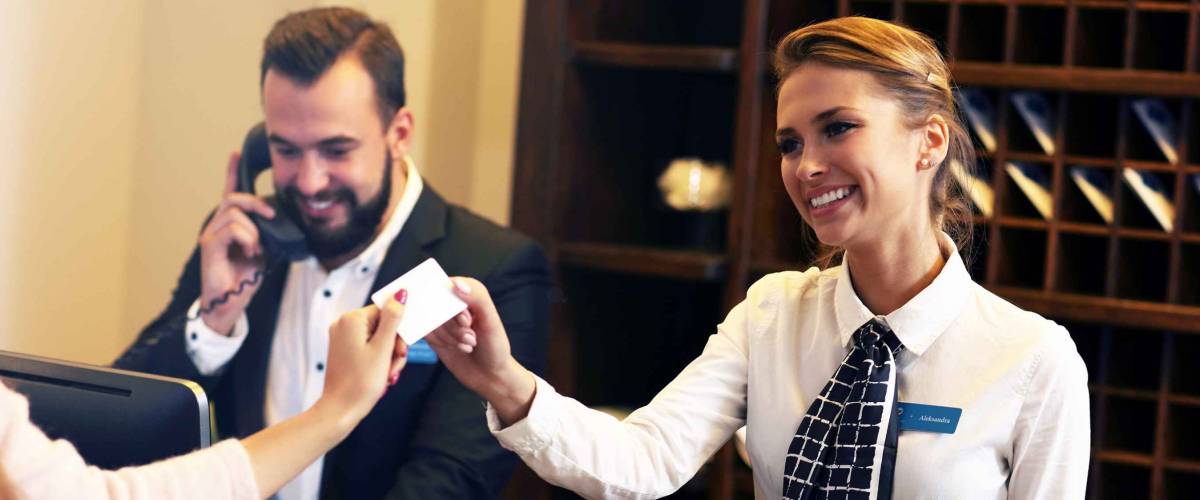 Picture of guests getting key card in hotel
