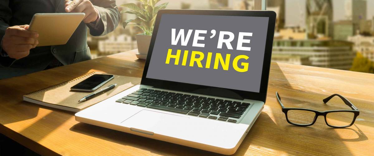We are hiring message displayed on a digital tablet screen,