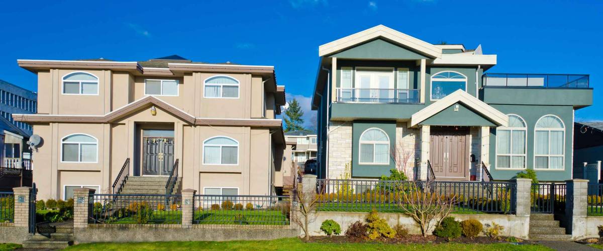 Two nice looking houses with blue sky as a background in a sunny day.