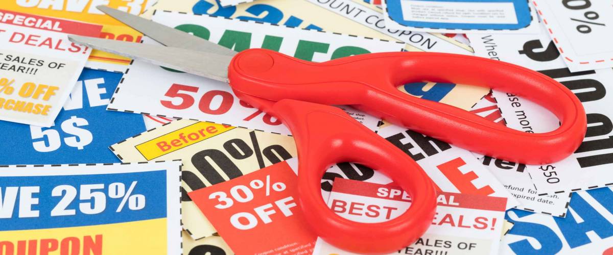 Saving discount coupon voucher with scissor, coupons are mock-up