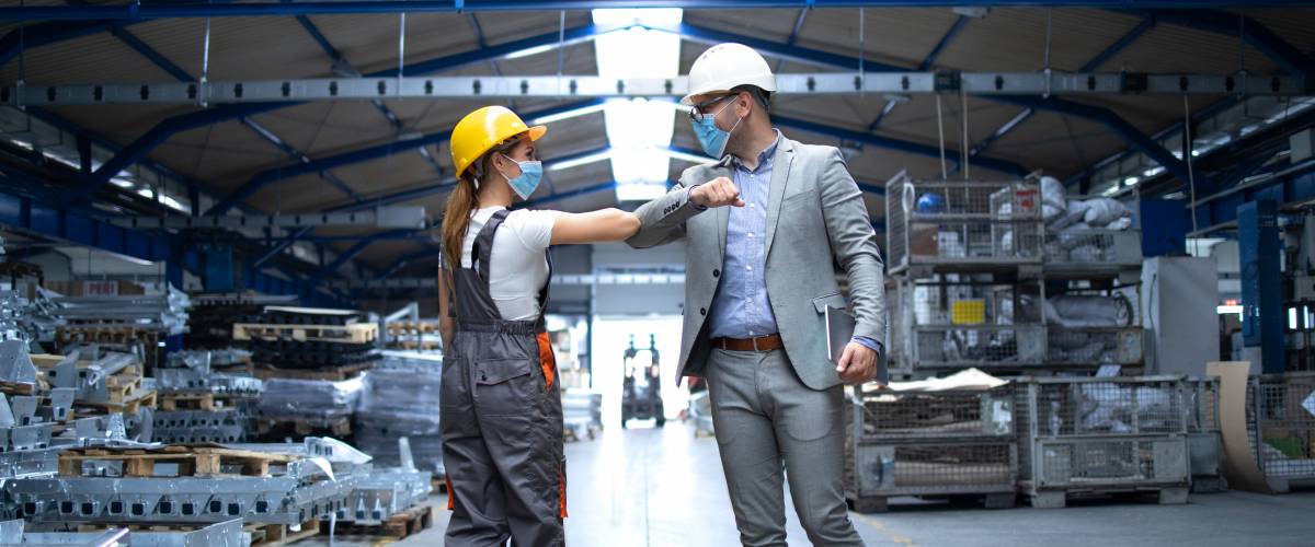 People at work greeting each other with elbow bump due to global corona virus pandemic and danger of infection
