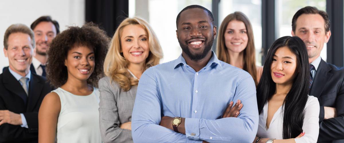 African American Businessman Boss With Group Of Business People In Creative Office,