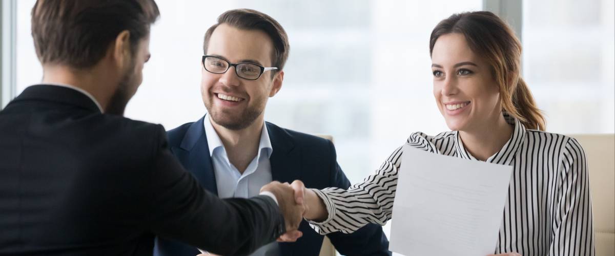 Happy employers shake hand of male job candidate, congratulating with given position,