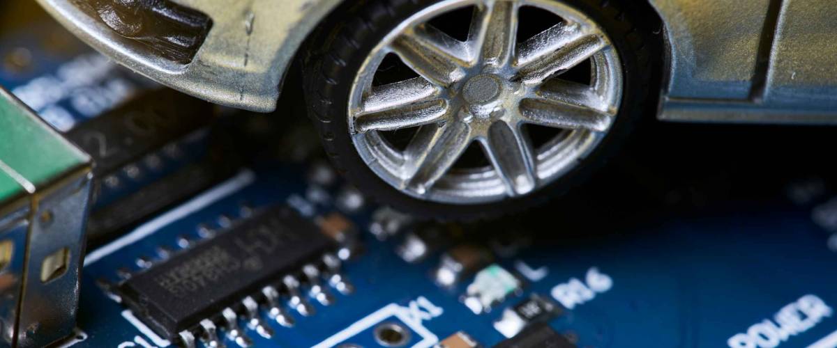 CPU chip and semiconductors with car toy. Global car chip shortage. Micro-chip shortage creates dearth of new cars. Computer chip shortage stalls car industry production