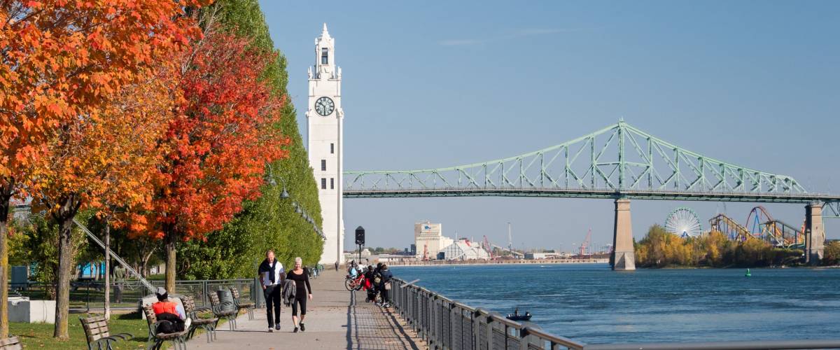 Montreal, CA - 21 October 2017: Montreal Clock Tower and Jacques Cartier Bridge with autumn colours
