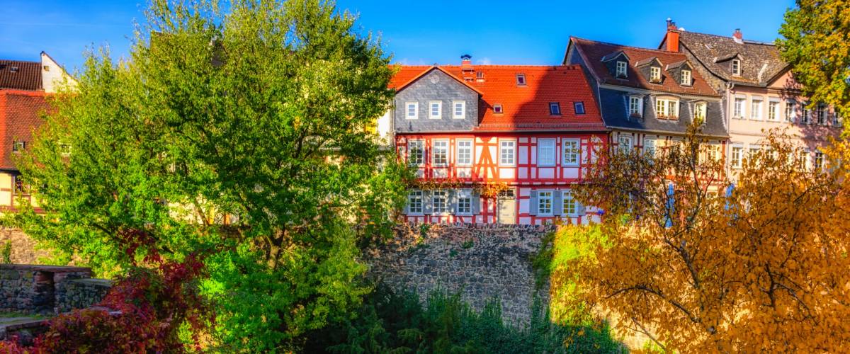Color image of the idyllic Frankfurt-Höchst, Germany, Europe, old historical town with old houses and the castle moat on a sunny fall day with blue sky and colorful autumnal trees
