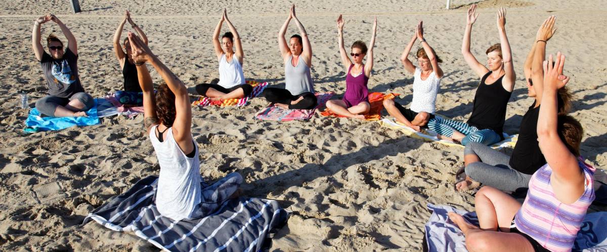 beach yoga group in the sand