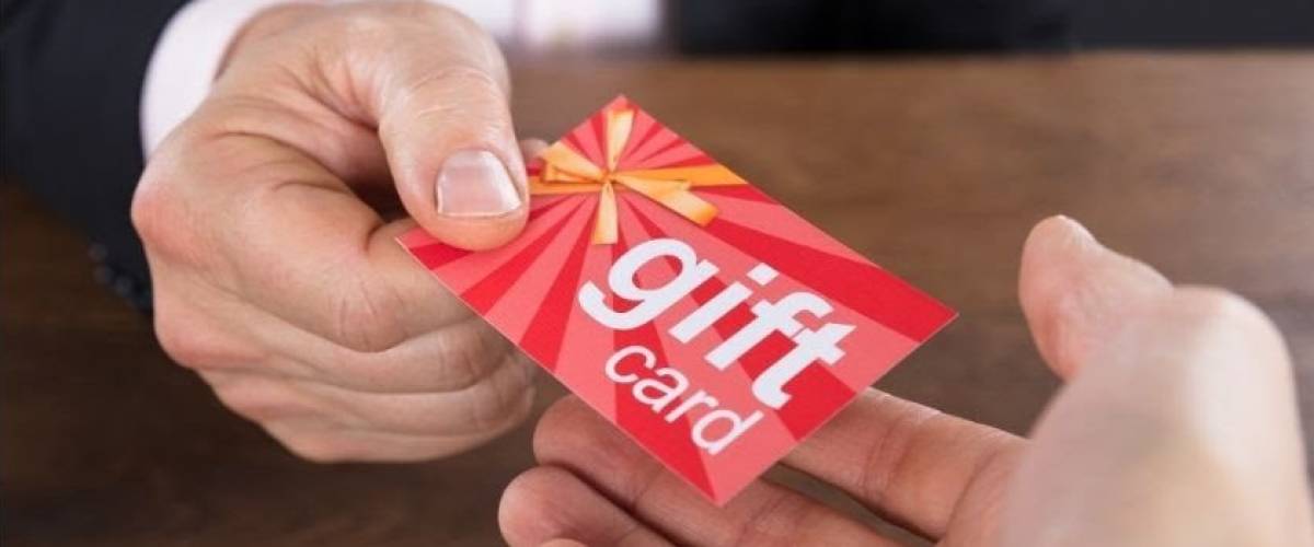 Someone handing someone a gift card