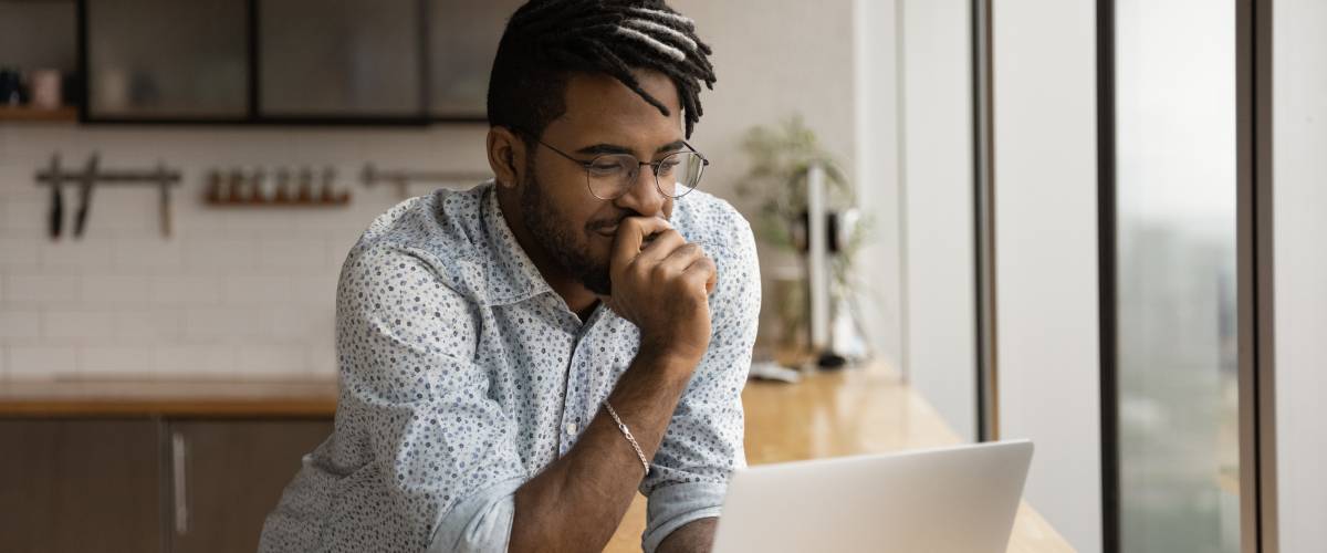 Man smirks at computer