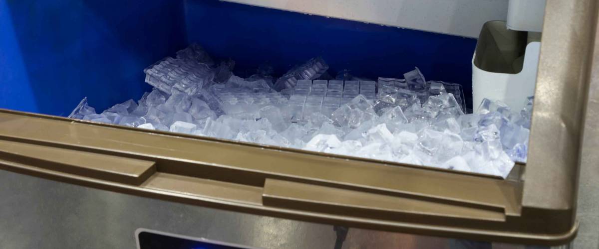cube ice from clean water in ice making machine for restaurant food industry background