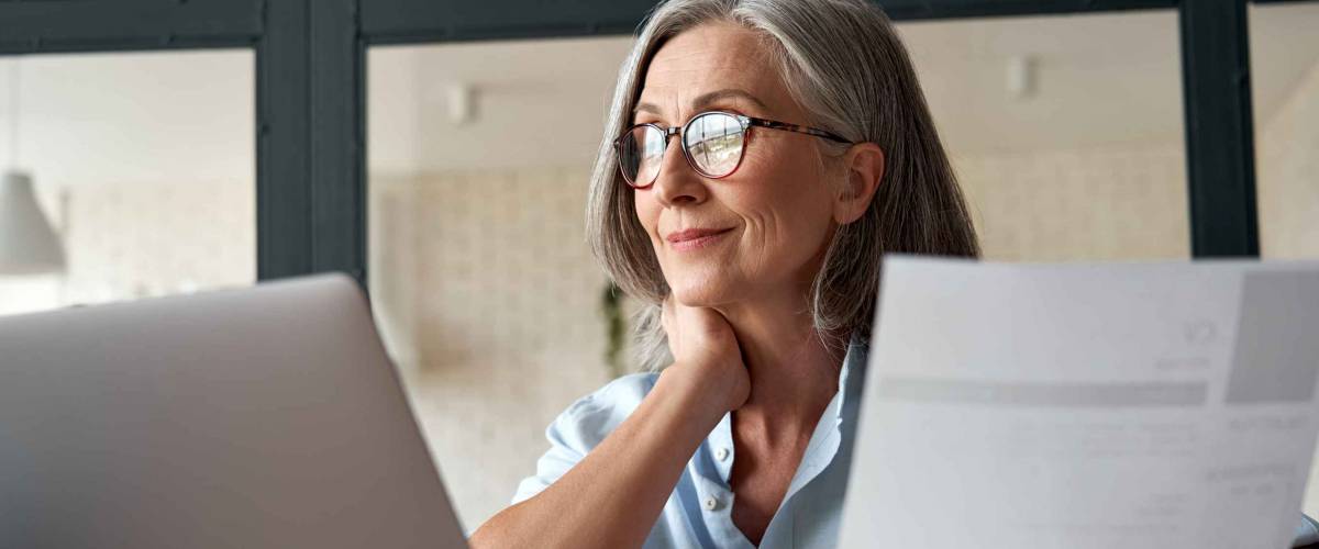 Smiling woman using laptop