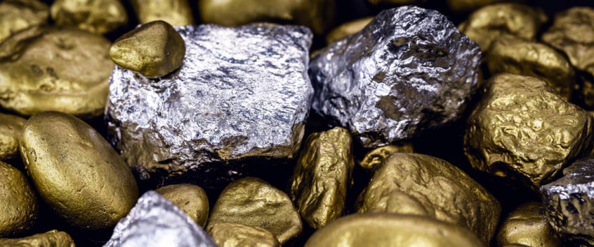 Gold and silver nuggets on black background.