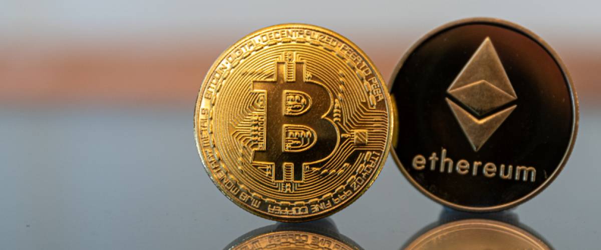 bitcoin ethereum coin in a line on a mirror