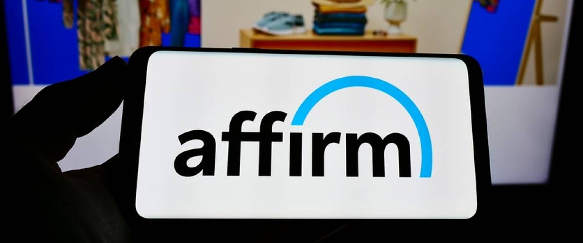 Person holding cellphone with logo of US financial technology company Affirm Holdings