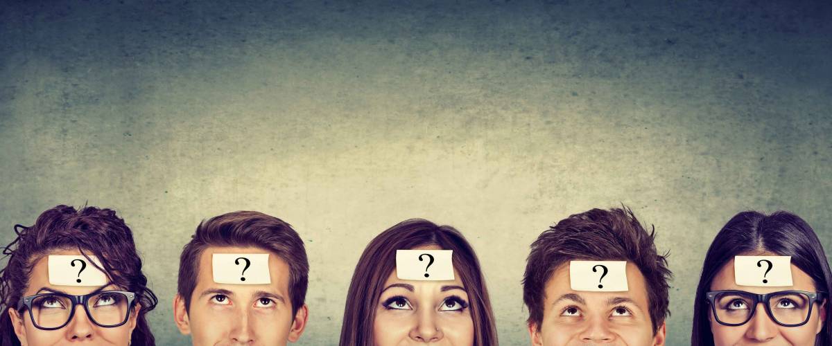 Multiethnic group of thinking people with question mark looking up