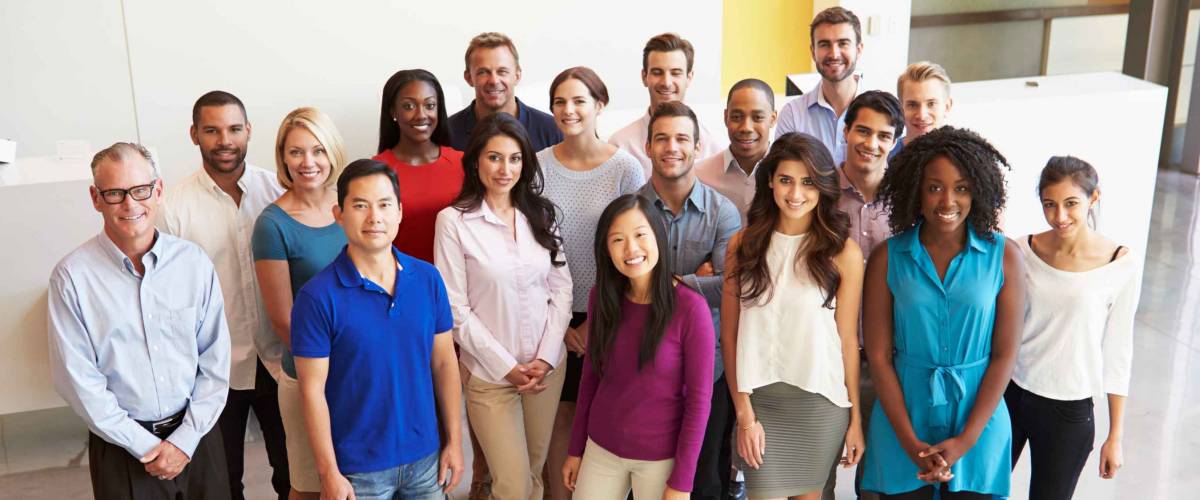 Portrait Of Multi-Cultural Office Staff Standing In Lobby