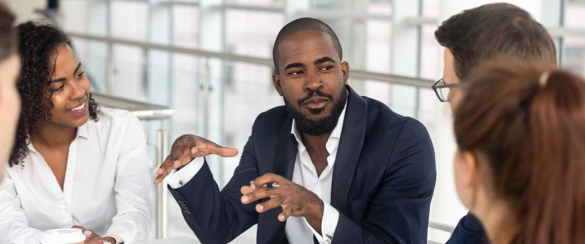 Millennial employees gathered in boardroom for training,. Leadership concept
