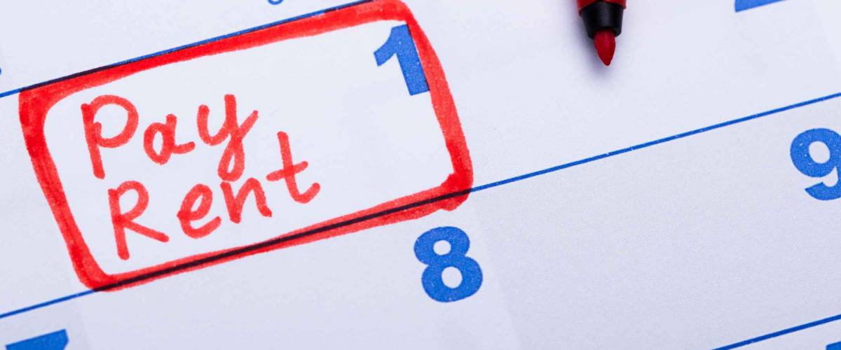 Pay Rent Note Made Using Red Marker In Paper Calendar