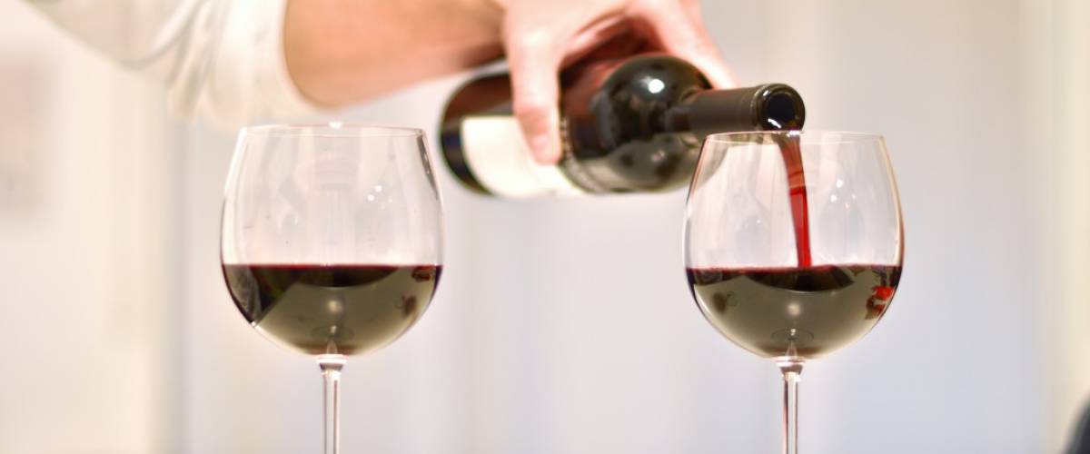 red wine is poured into crystal goblets