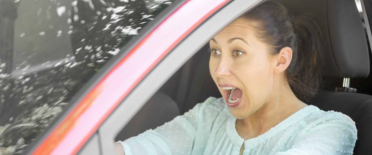 Girl in the red car emergency brake. Road trip risk danger concept.