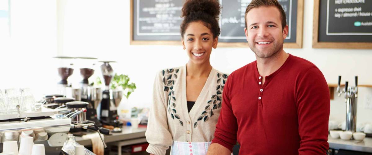 Male And Female Staff In Coffee Shop
