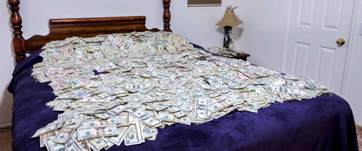 A large bed covered in money