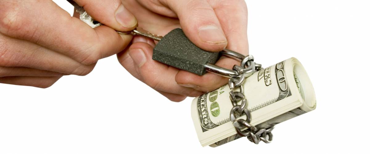 Dollars locked a chain on a white background