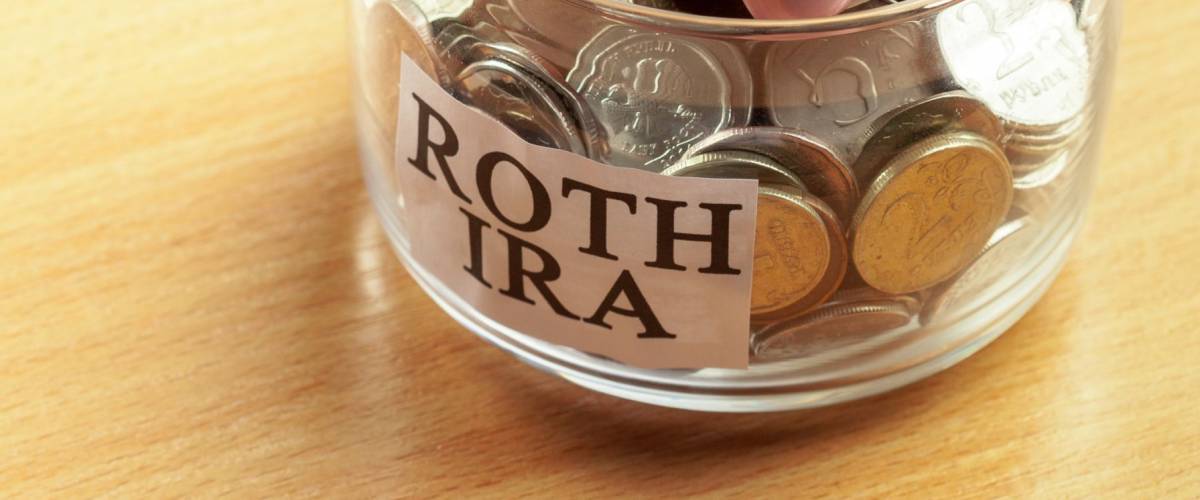 glass jar used for saving US dollar bills and notes for IRA retirement fund
