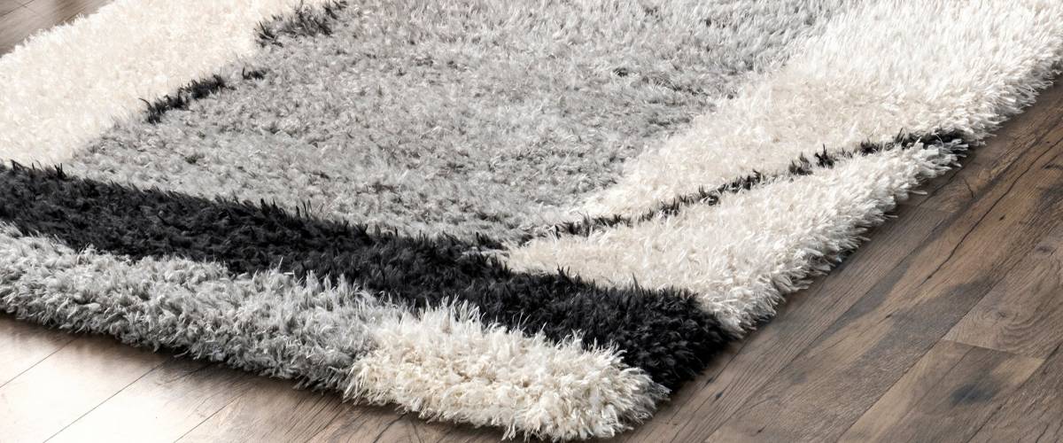 Black, white and grey shag rug on hardwood floor