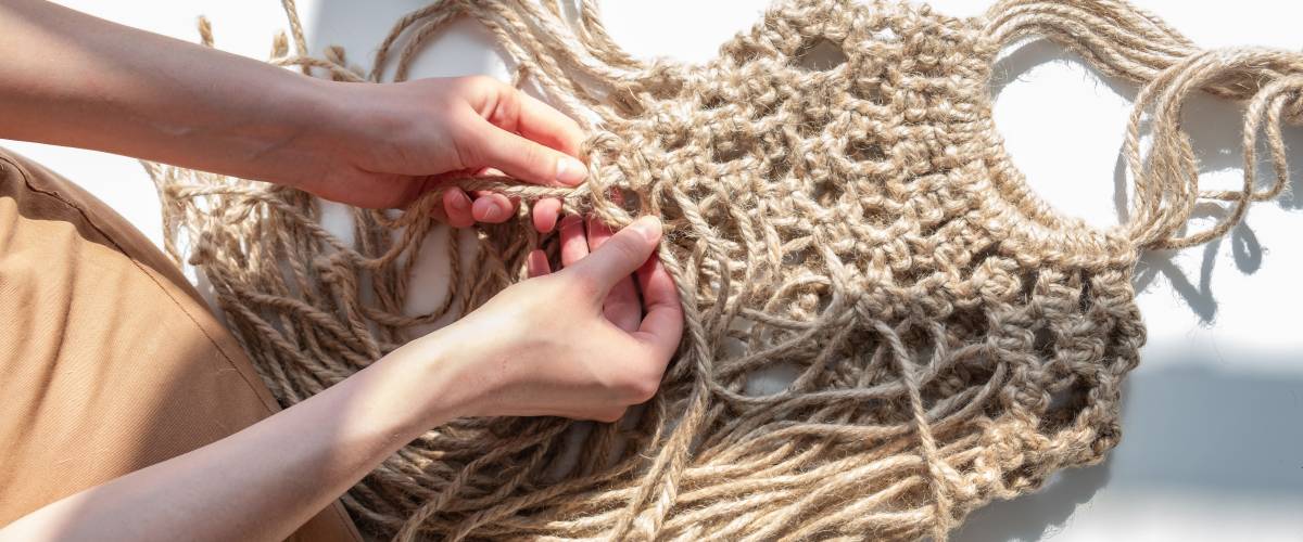 Person making macrame bag