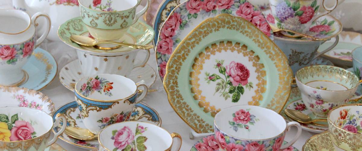 Fine china cups and saucers on display with floral designs