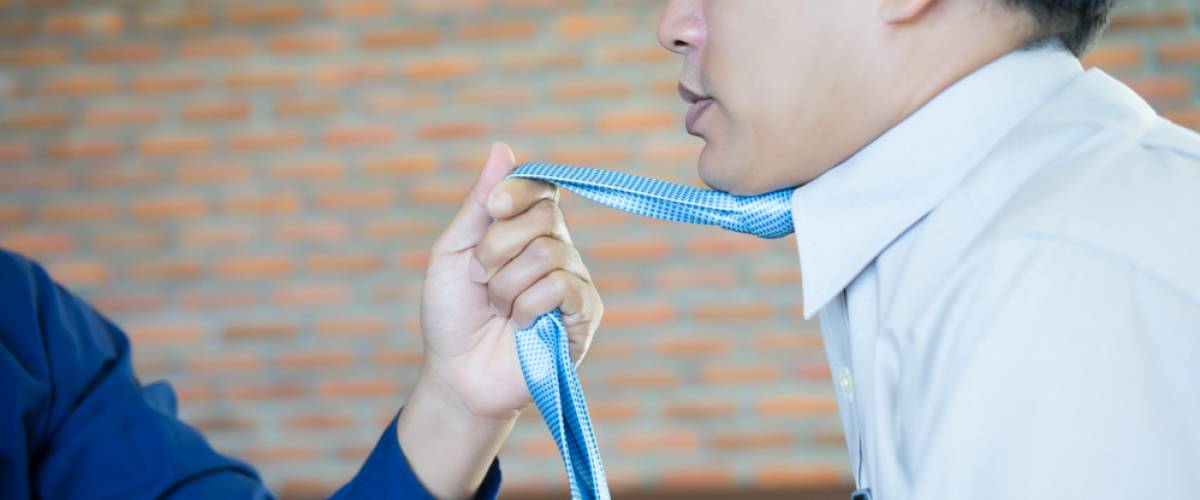 worker being choked by tie