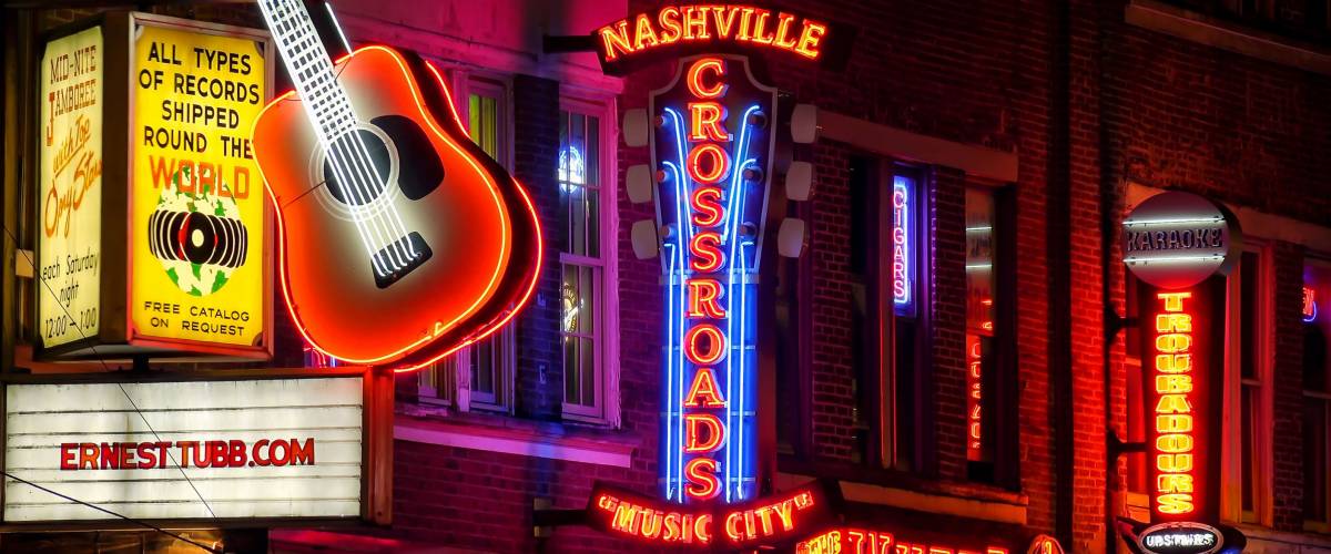 NASHVILLE, TENNESSEE - JULY 7th: Neon signs at night along Broadway Street in Nashville, Tennessee on July 7th, 2016.