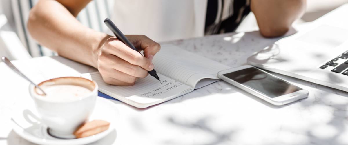 woman writing in a notebook