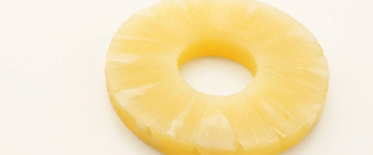 Canned pineapple ring isolated on white