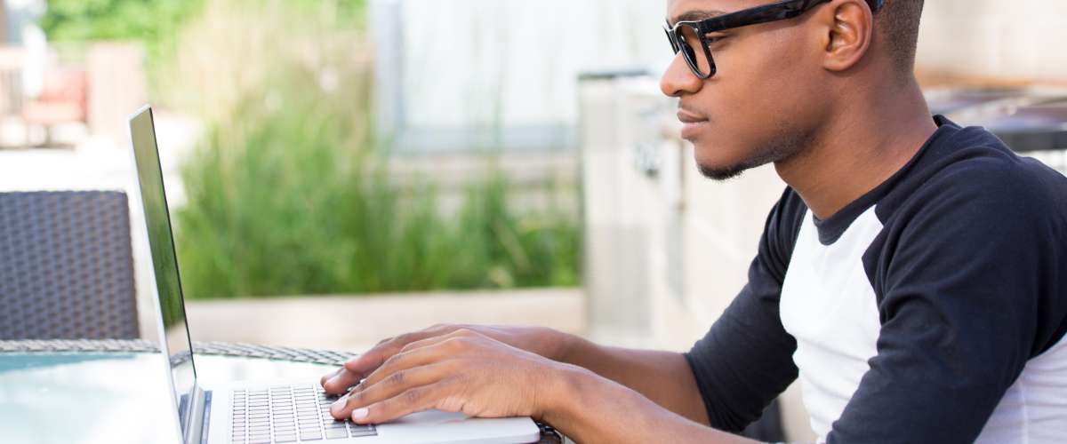 young man doing research on his computer