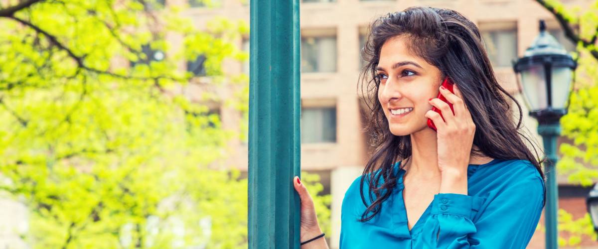 East Indian American Business Woman Calling Outside in spring day.