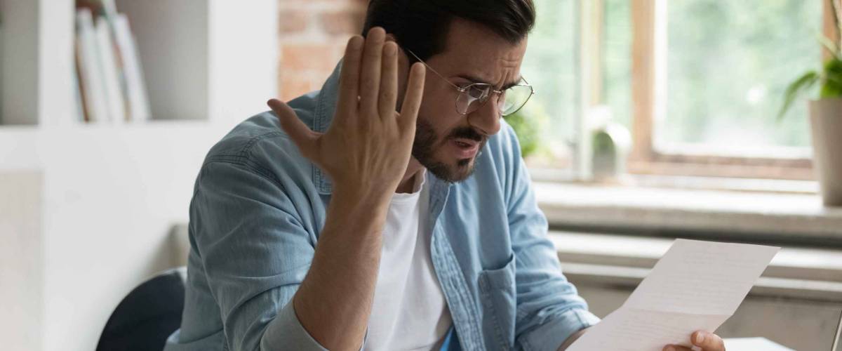 Unhappy man feels stressed about a letter he's been given
