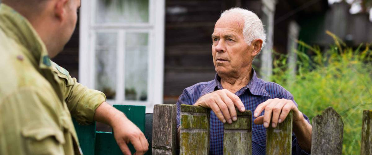 Senior man having conversation with his neighbour