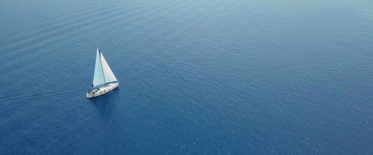 Yacht sailing on opened sea. Sailing boat. Yacht from drone. Yachting video. Yacht from above. Sailboat from drone. Sailing video. Yachting at windy day. Yacht. Sailboat.
