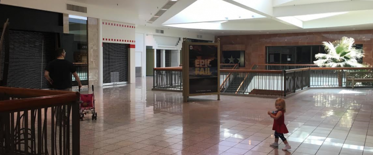 Mall visitors mill inside the nearly vacant wing of Fiesta that Macy's department store once anchored. Vacancy rates hit unprecedented highs after the 2008 recession.