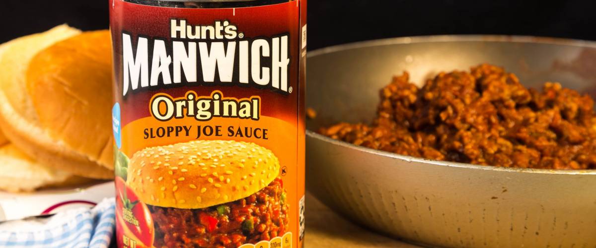 LLANO, TX-SEPT 24, 2015: Can of Hunt's Manwich Original Sloppy Joe Sauce with buns and skillet of Sloppy Joe Mix.