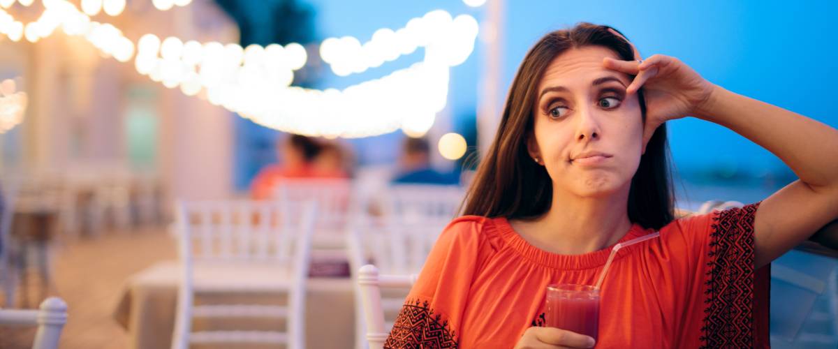 Woman getting stood up for date on boardwalk