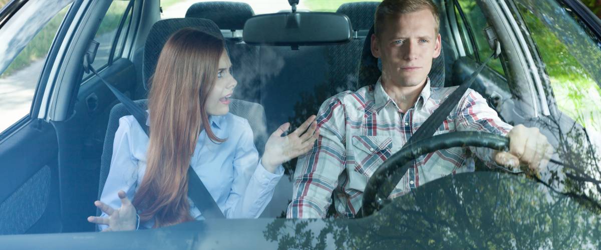 Man and woman arguing in car