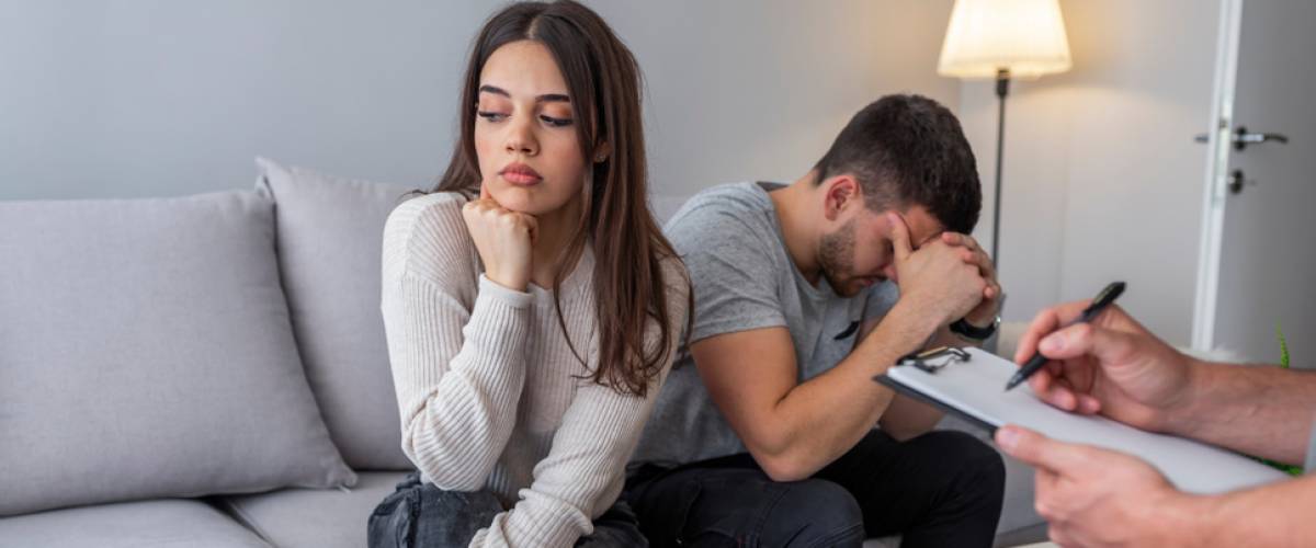 Man and woman looking frustrated during couple's therapy session