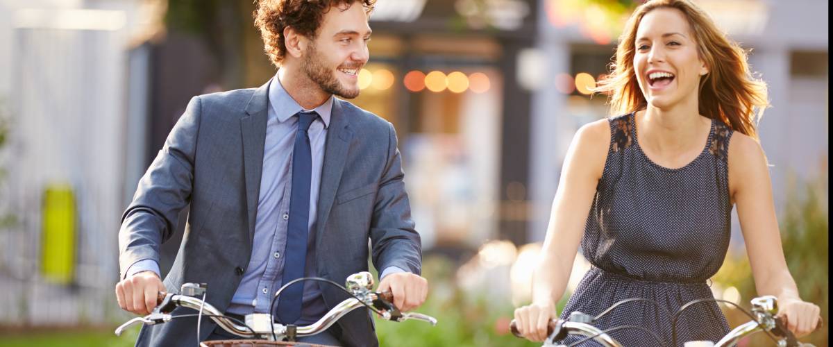 Young couple riding bikes together