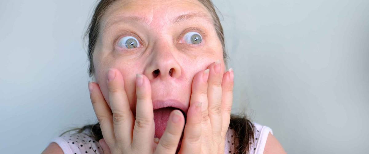 European elderly woman shocked by what is happening, screaming, opening her mouth, face close-up, concept shock content, incredible information, a person is outraged, expressive emotions