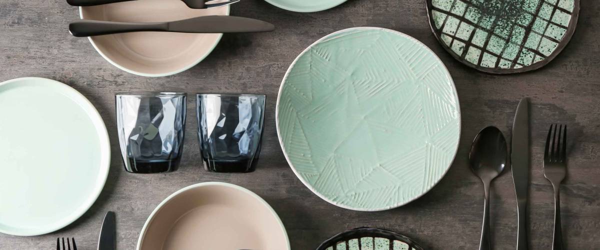 Set of clean tableware on grey background